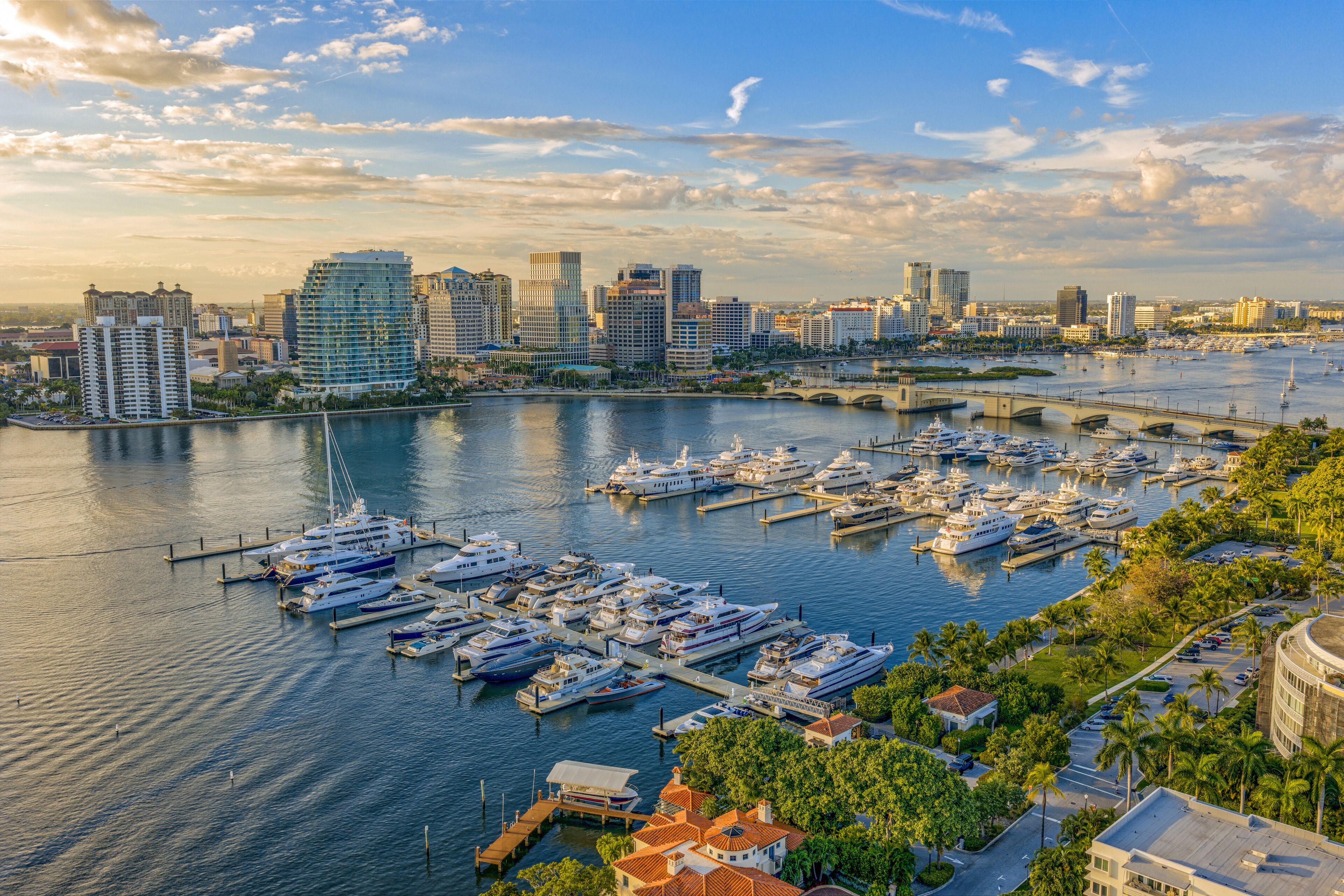 Palm Beach Florida waterfront aerial view of yachts and skyline at sunset